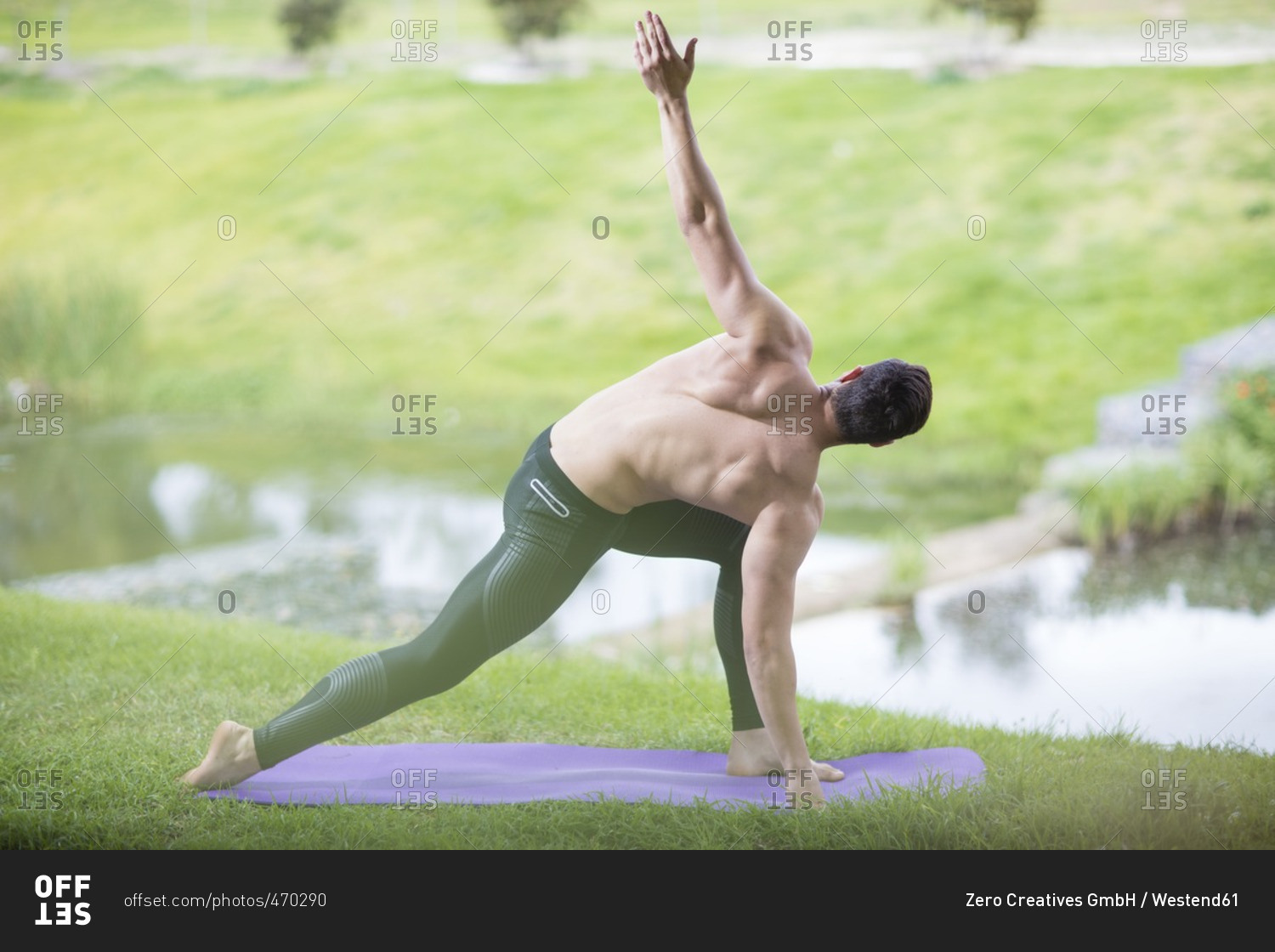 Young man practicing yoga in park
