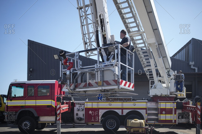 Mechanics maintaining fire engine - Offset