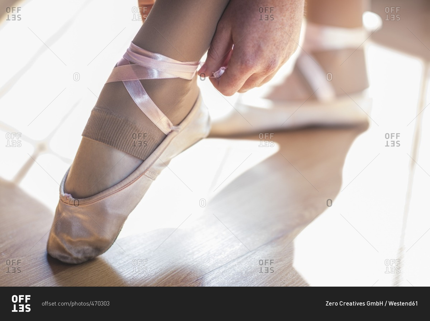 Ballet dancer putting shoes on