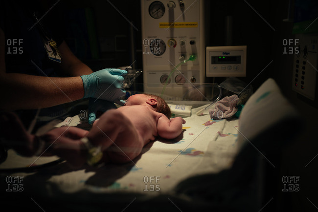 Healthcare professional examining newborn - Offset
