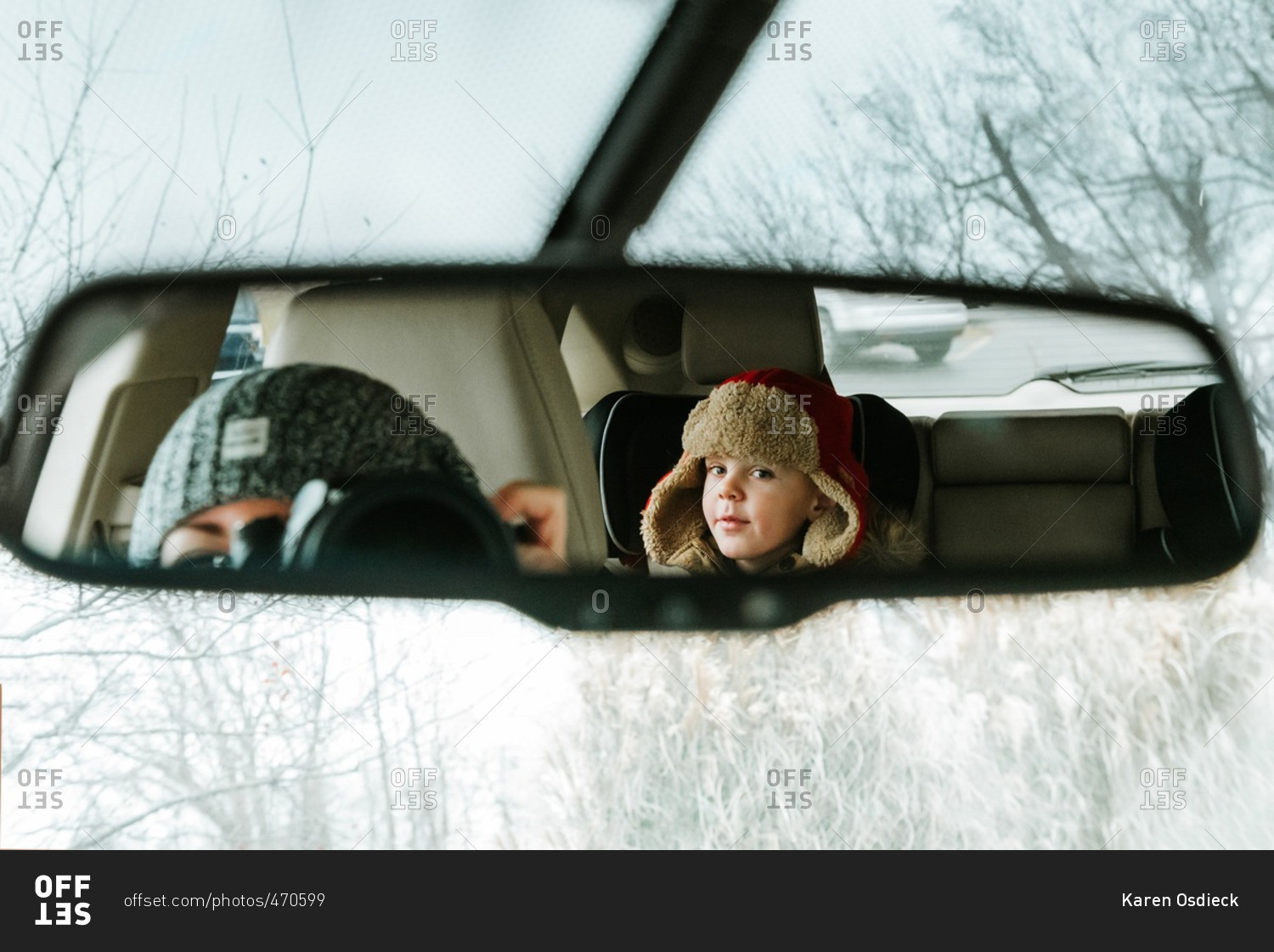 Mother taking photo in rearview mirror 
