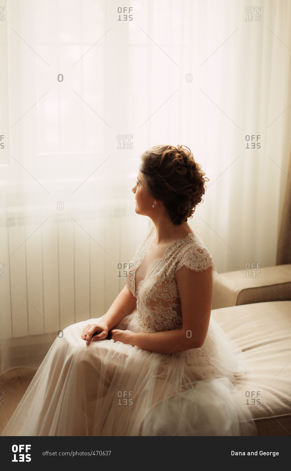 Portrait of seated bride in a classic lace dress
