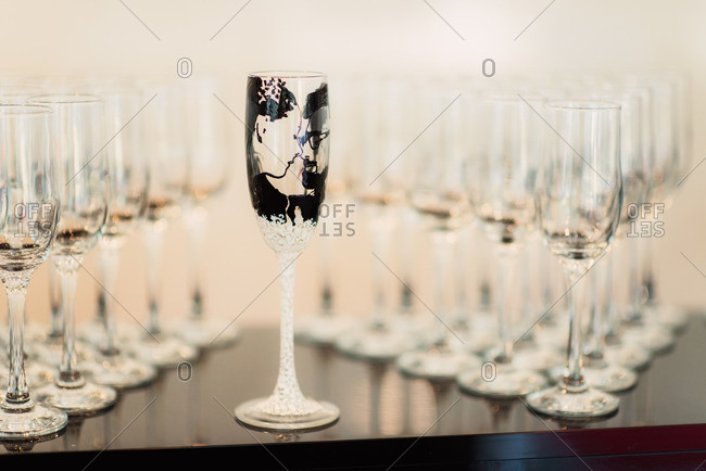 Champagne glasses, one with illustration of bride and groom