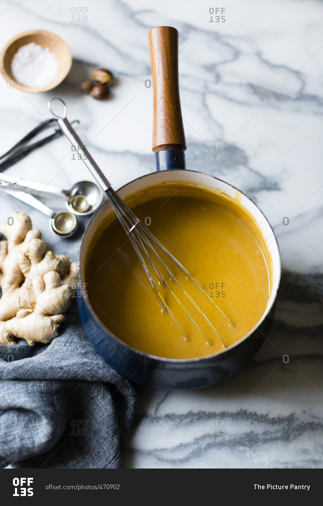 Pumpkin puree and whisk in a sauce pan stock photo OFFSET