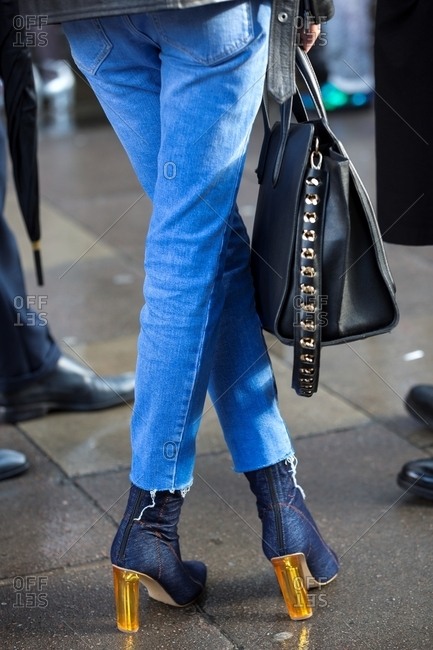 Woman in high heel denim boots and jeans