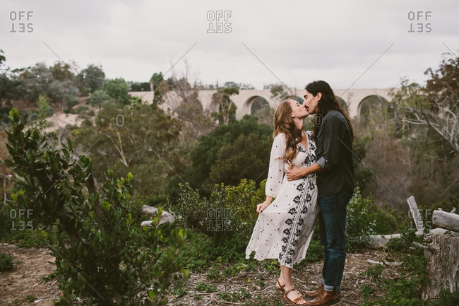Couple kissing each other on a nature trail