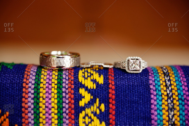 Wedding rings on a colorful woven fabric
