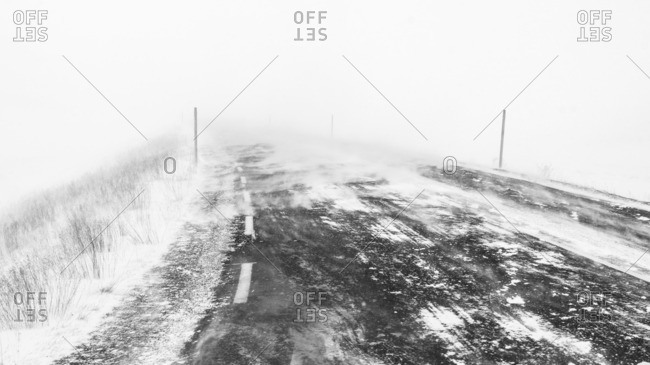 Snow covered road during foggy weather