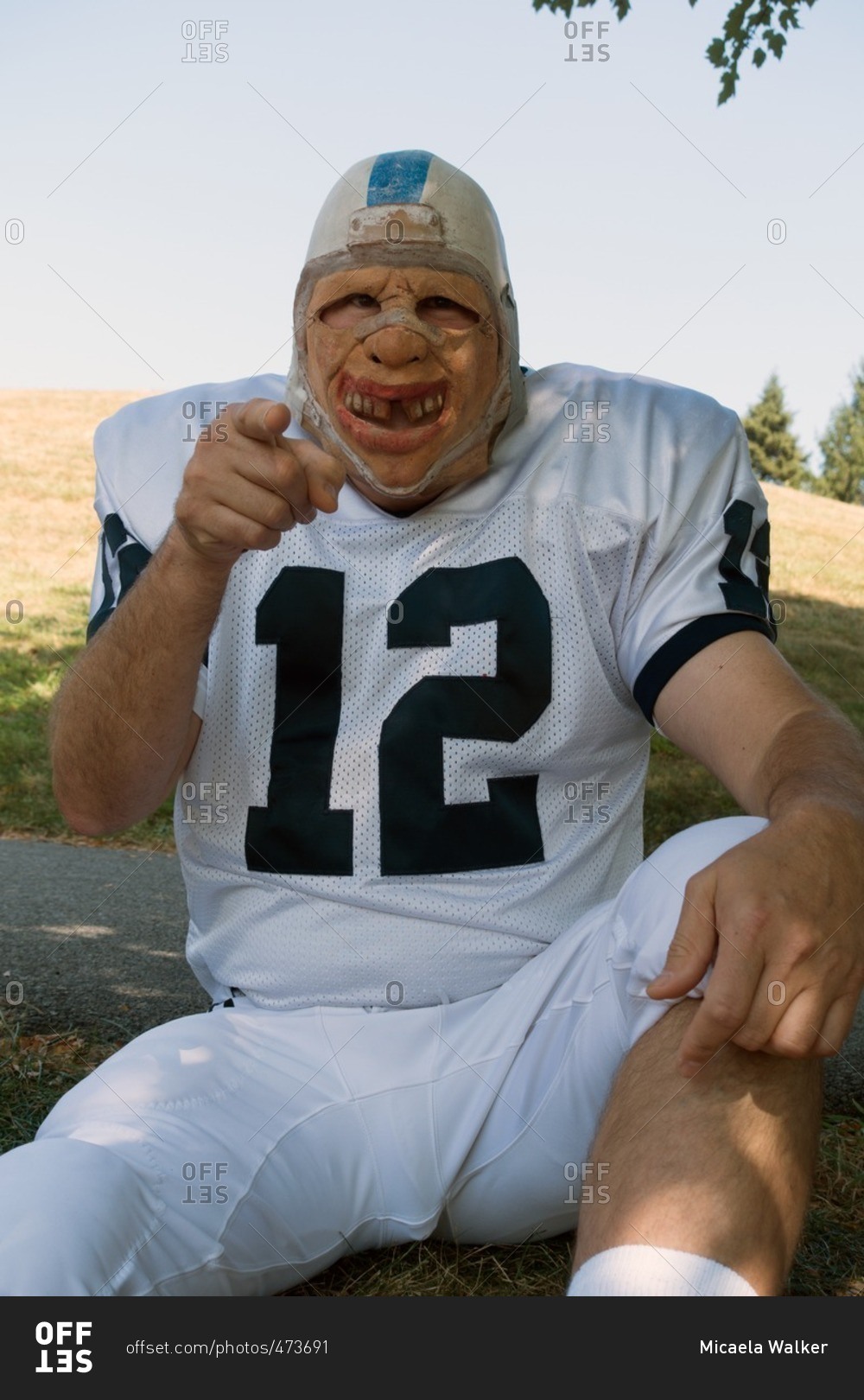 Man in creepy mask and football uniform