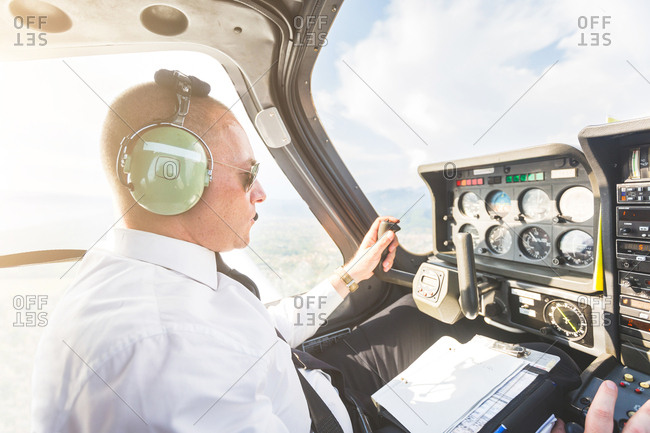 Pilot in cockpit of aircraft, in flight