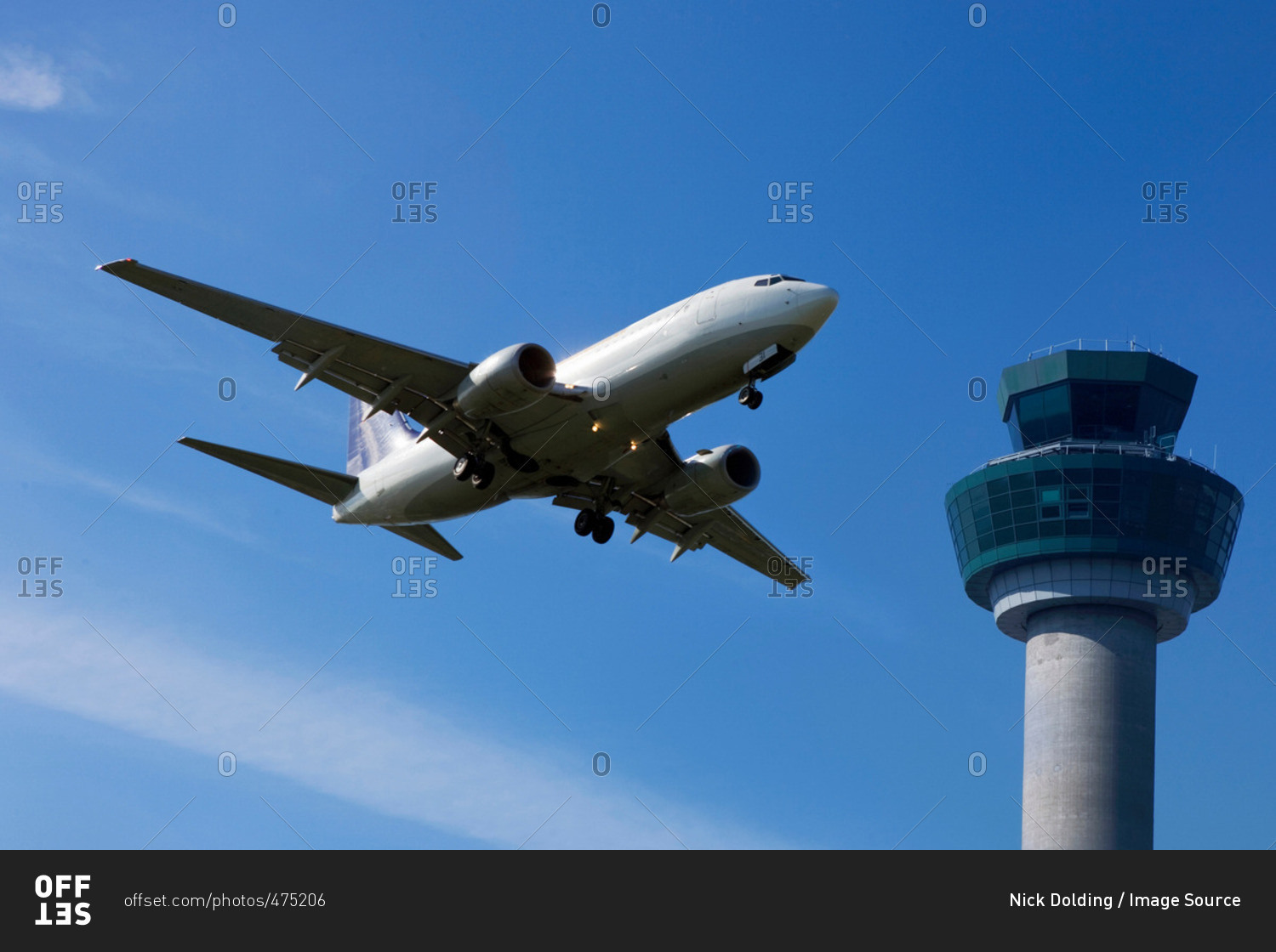 Plane flying past control tower