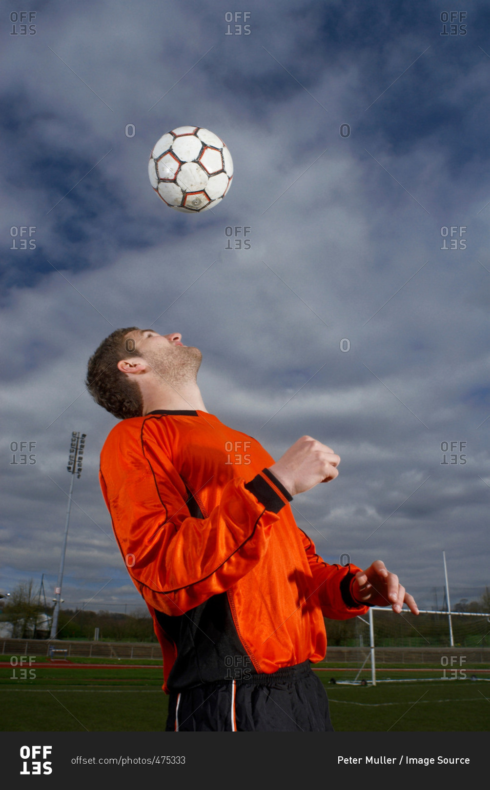 footballer heading a ball to himself