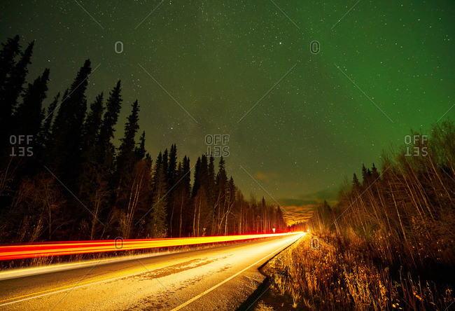 Blurred headlights on a highway at night in Alaska