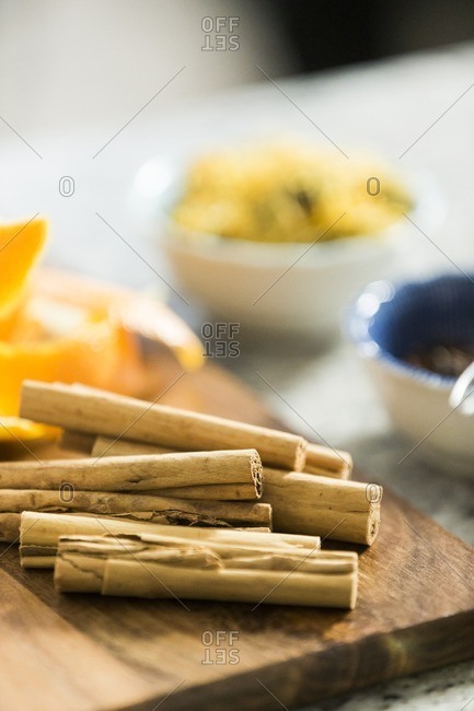 Cinnamon sticks and citrus rind on wooden board
