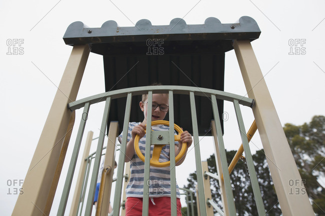 Boy using steering wheel in playground