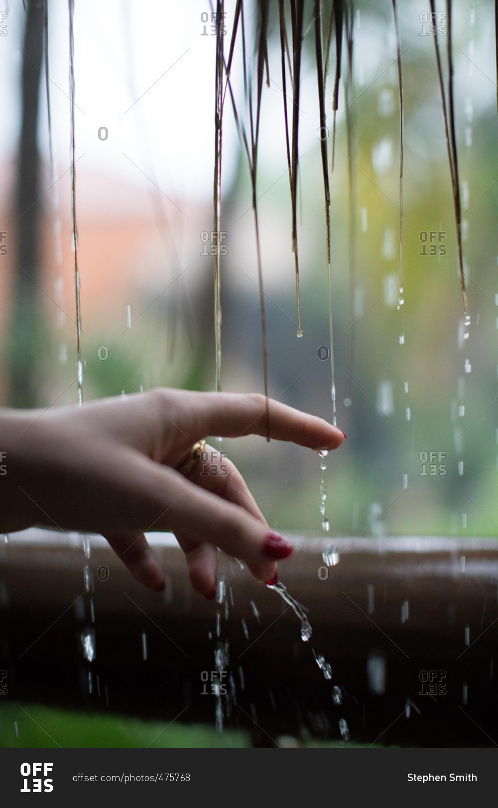 Woman holding hand under dripping water