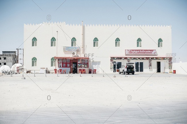 Oman - October 19, 2016: Restaurant and car in desert against sky