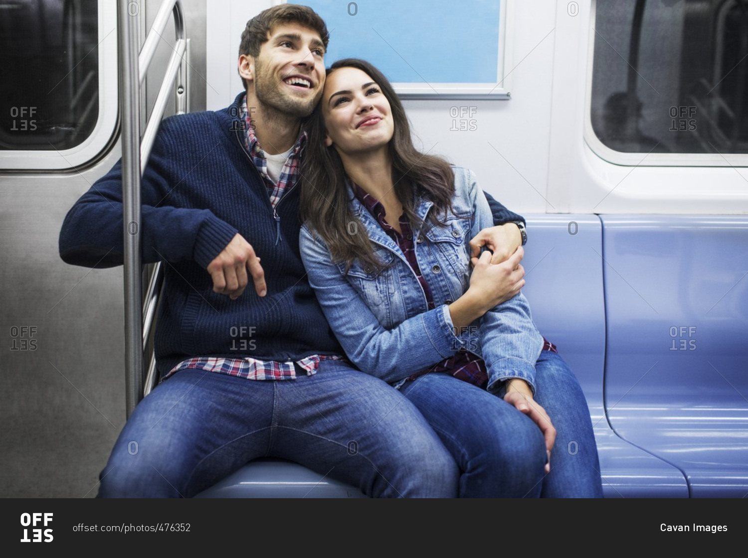 Happy couple traveling in train