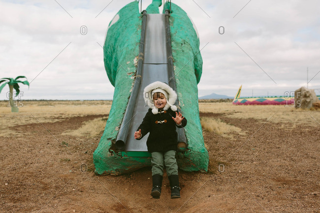 Girl on a dinosaur shaped slide