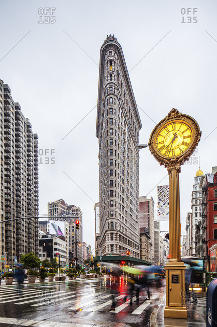 Flatiron District, Manhattan, New York City, United States, USA - December 22, 2016: The clock and the Flatiron Building on Fifth Avenue with the rain