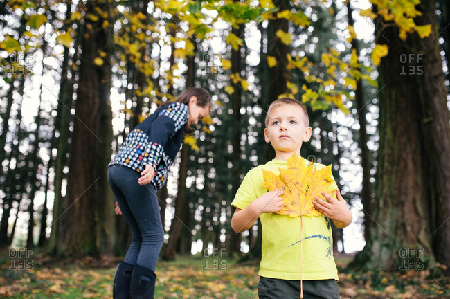 Boy holding fall leaf by girl