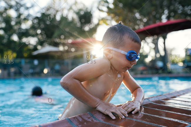 Boy climbing out of a pool