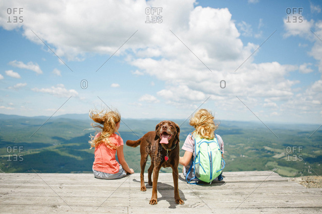 Two girls and dog on scenic overlook