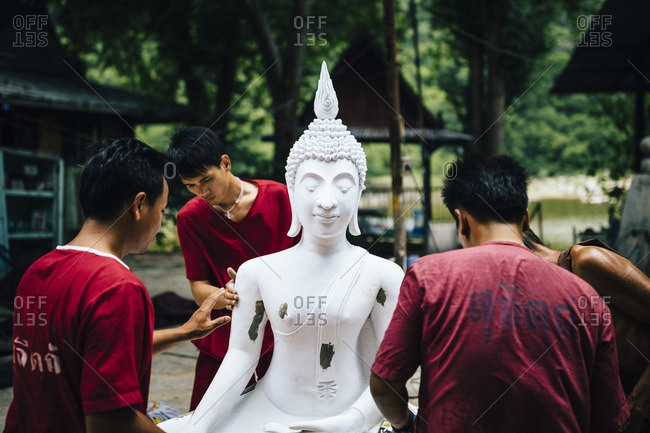 8/9/16: A monk and drug rehab patients work to put together a stone Buddha statue at one of Tham Krabok's many workshops. The temple provides these statues to other monasteries throughout Thailand.