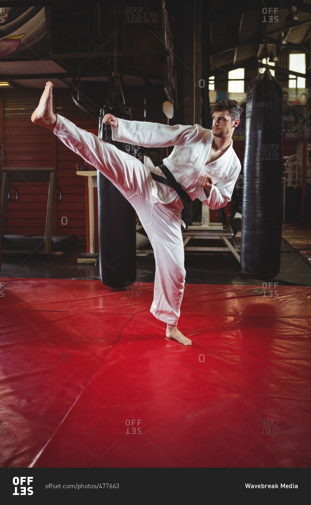 Karate practicing kickboxing in fitness studio
