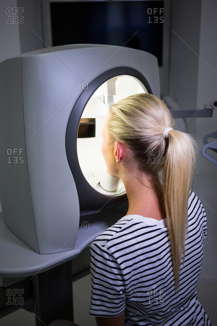 Woman receiving aesthetic laser scan in clinic