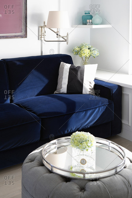 Corner of room with blue velvet sofa