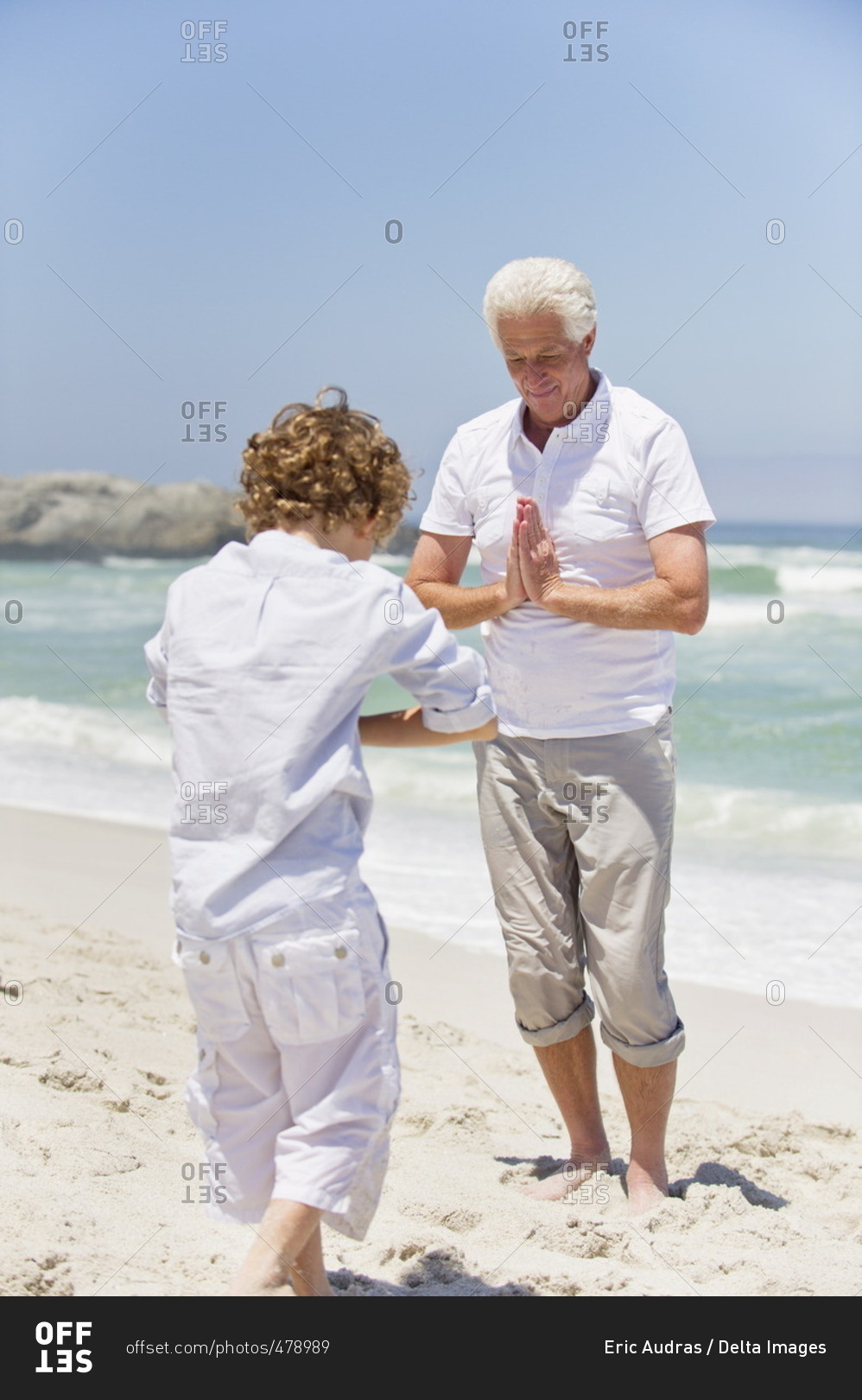 Senior man teaching martial arts to his grandson