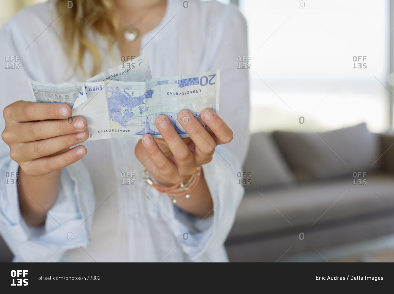 Mid section view of a girl holding paper currency