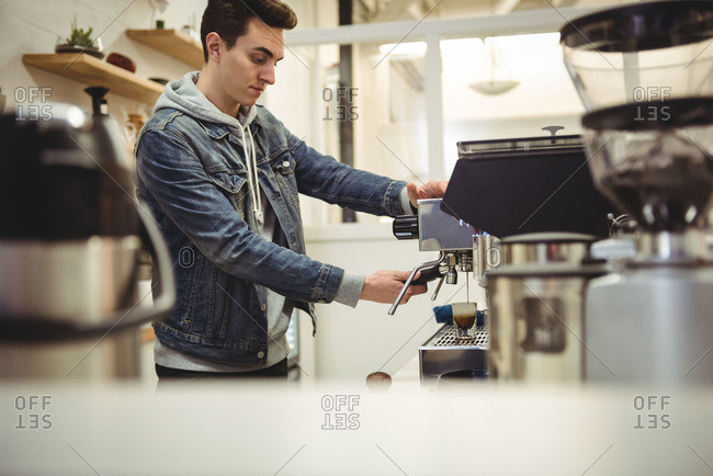 barista holding tamper near portafilter with grinded coffee, espresso, manual  press Stock Photo by LightFieldStudios