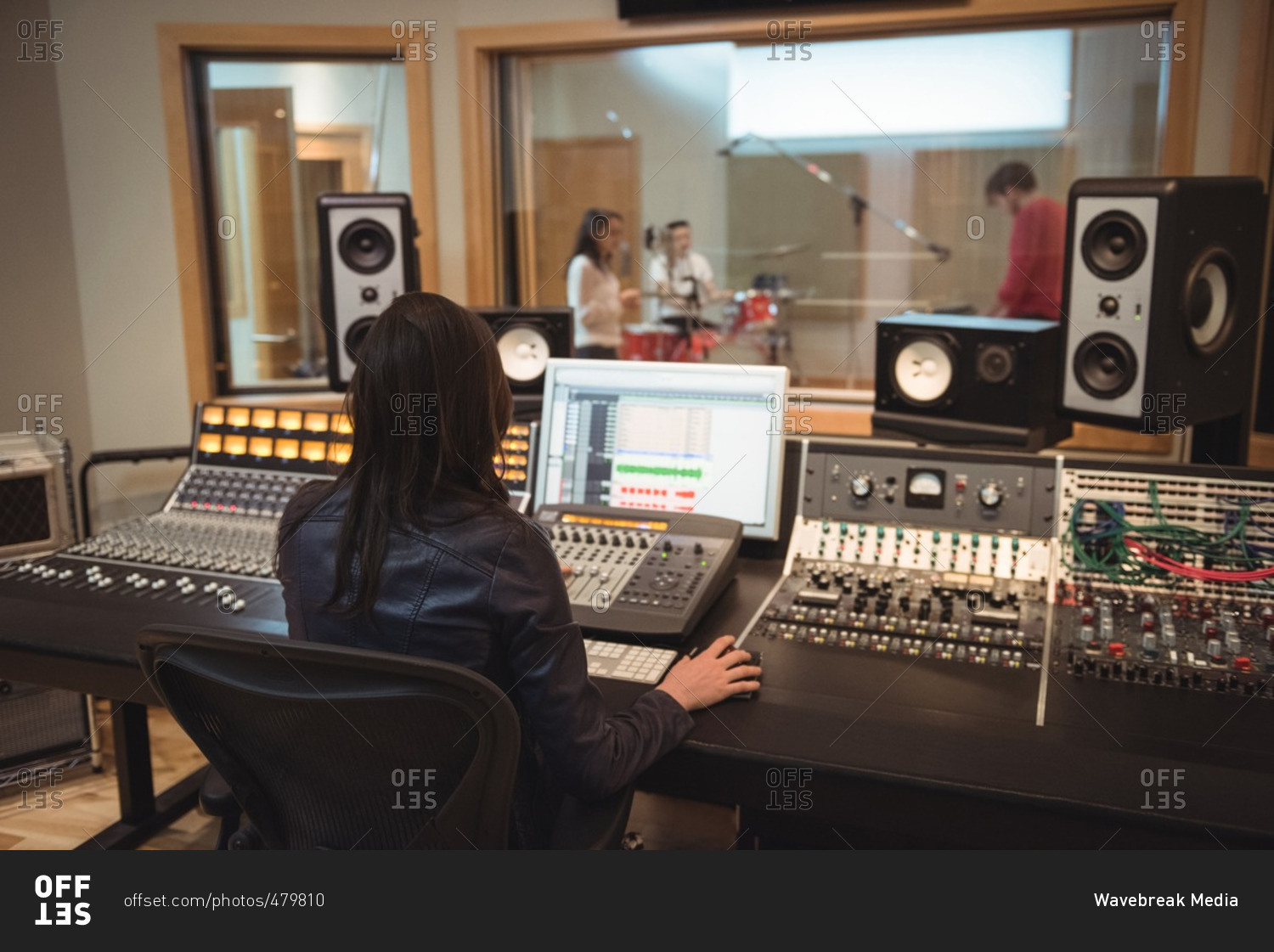 Audio engineer using sound mixer in recording studio
