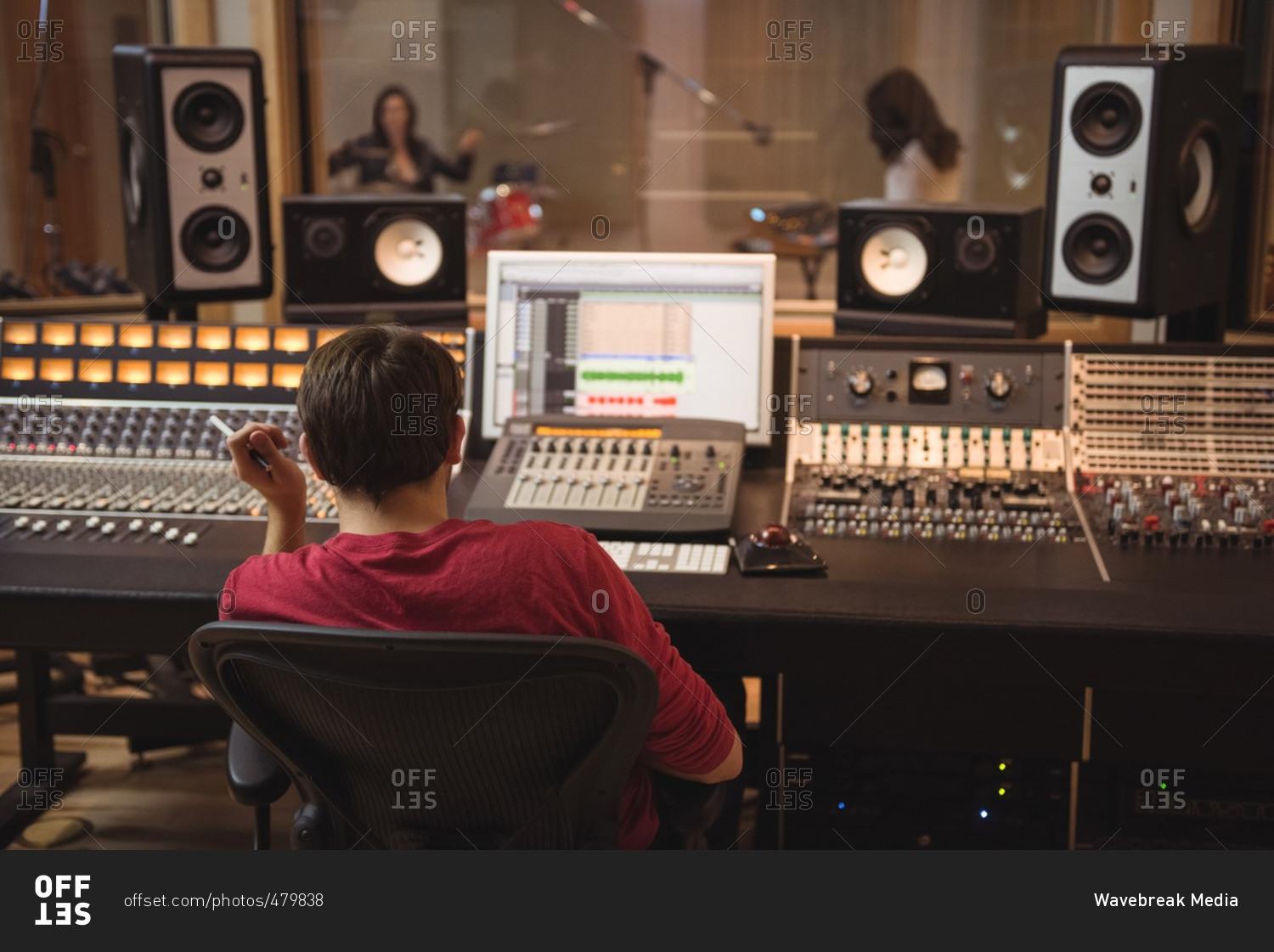 Audio engineer working on sound mixer in recording studio