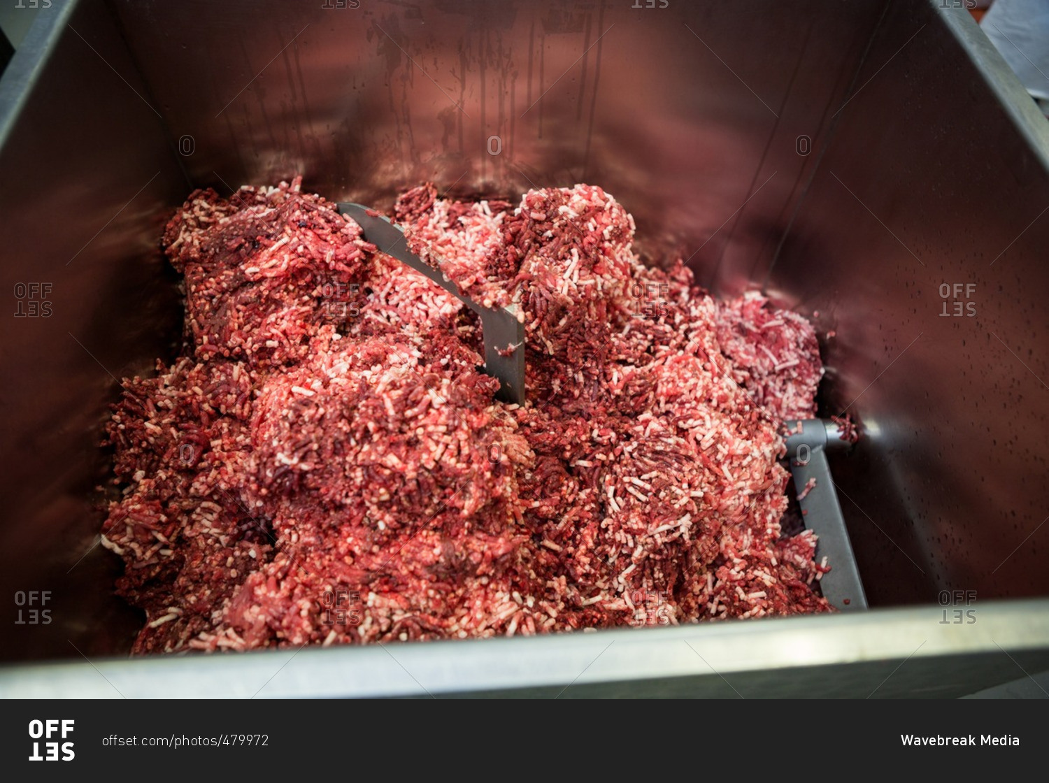 Close-up of meat mincing machine at meat factory