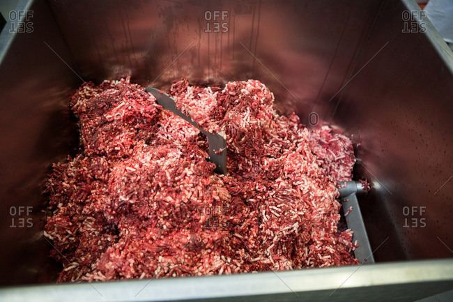 Close-up of meat mincing machine at meat factory