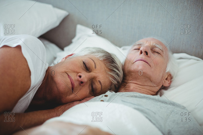 man and woman sleeping in bed stock photos - OFFSET