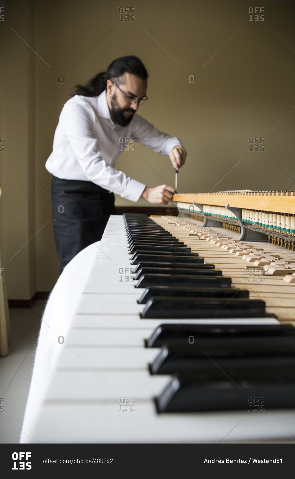 Piano tuner tuning grand piano