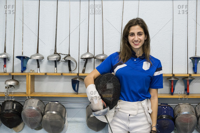 Portrait of three female fencer with fencing masks and weapons