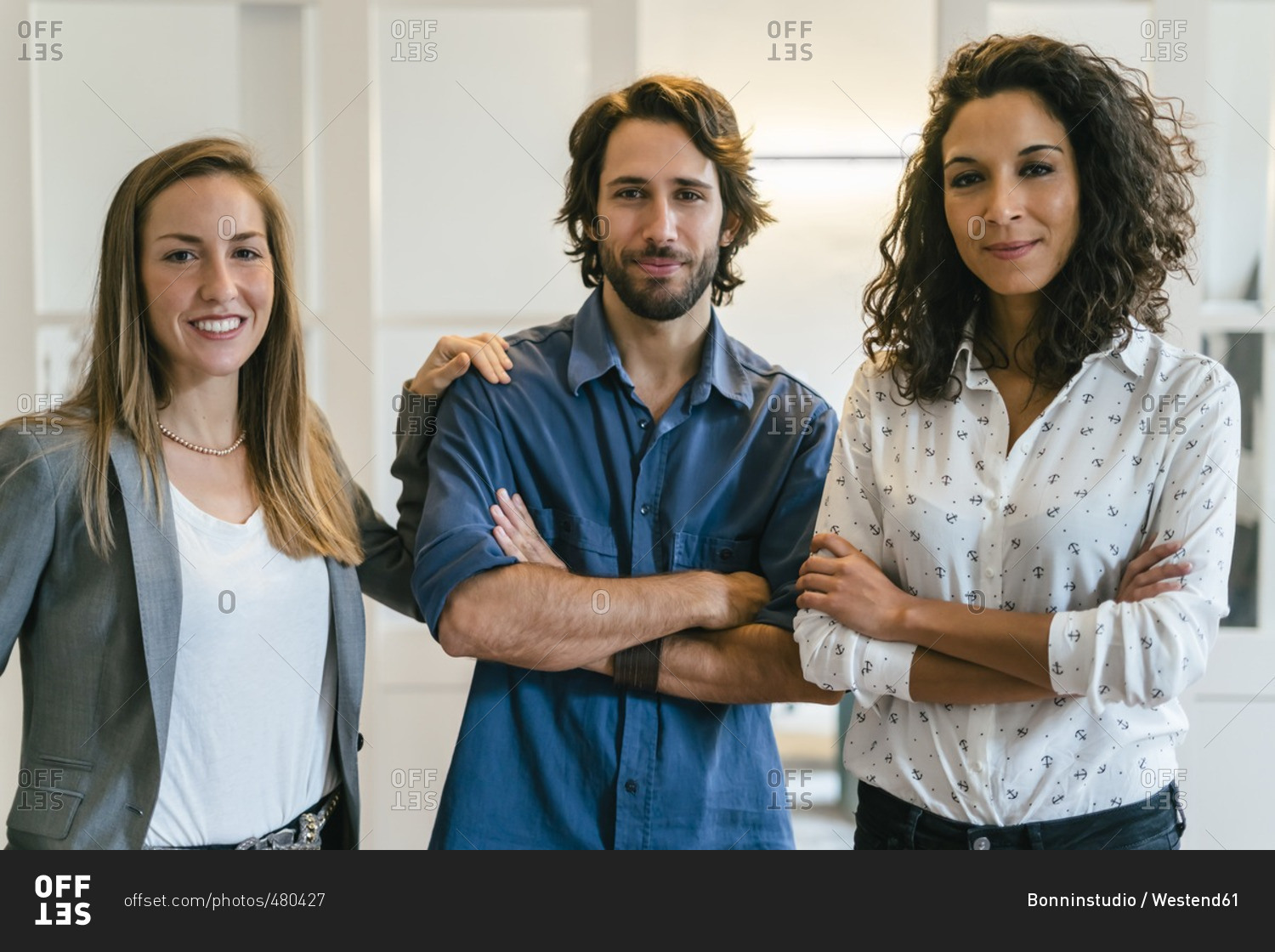 Group of confident business people standing in office
