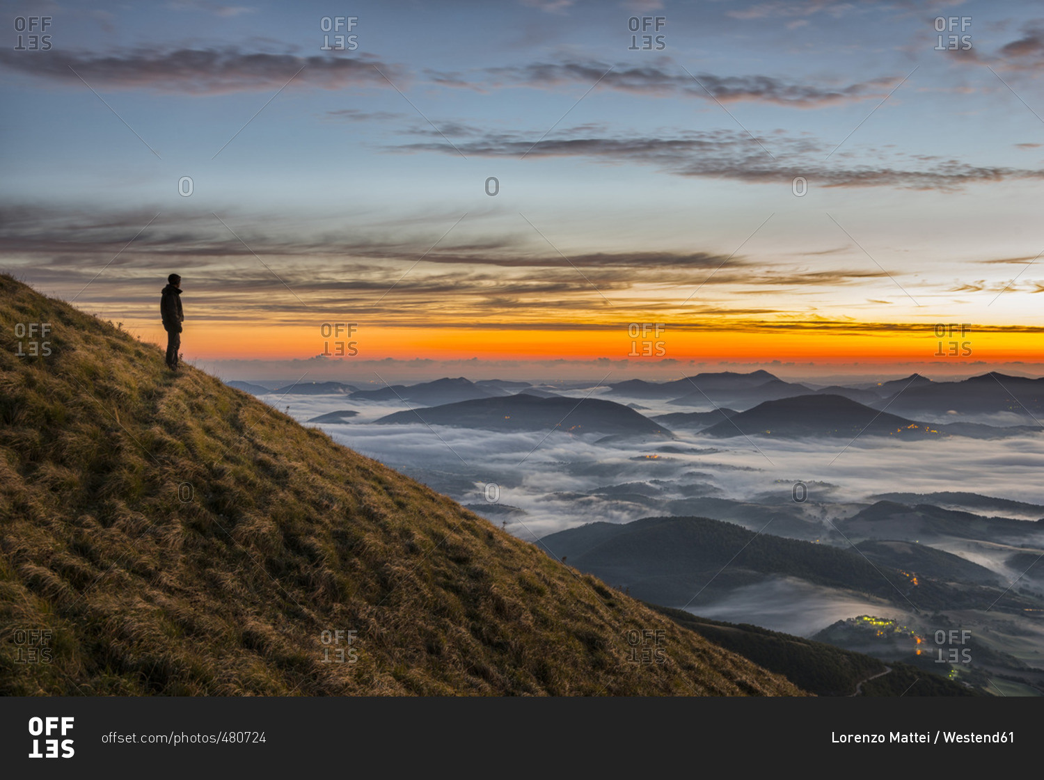 Hiker  standing on Monte Acuto watching sunrise