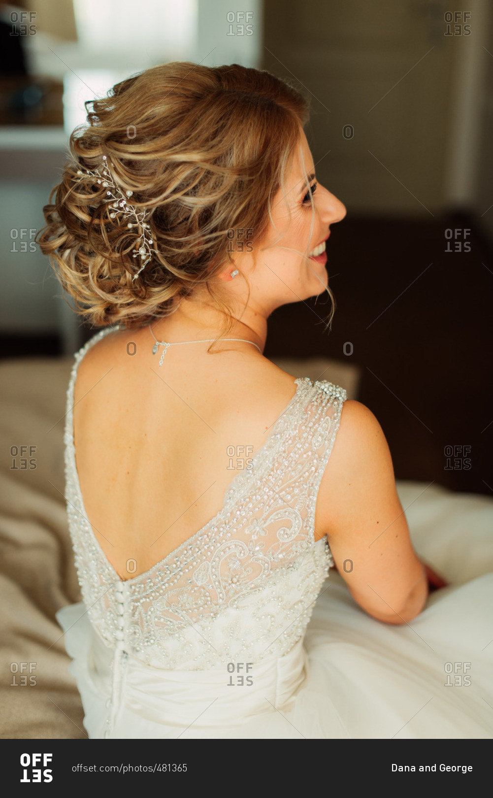 Smiling woman sitting in bridal wear