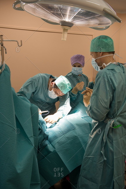 Medical team operating a patient in an operating room