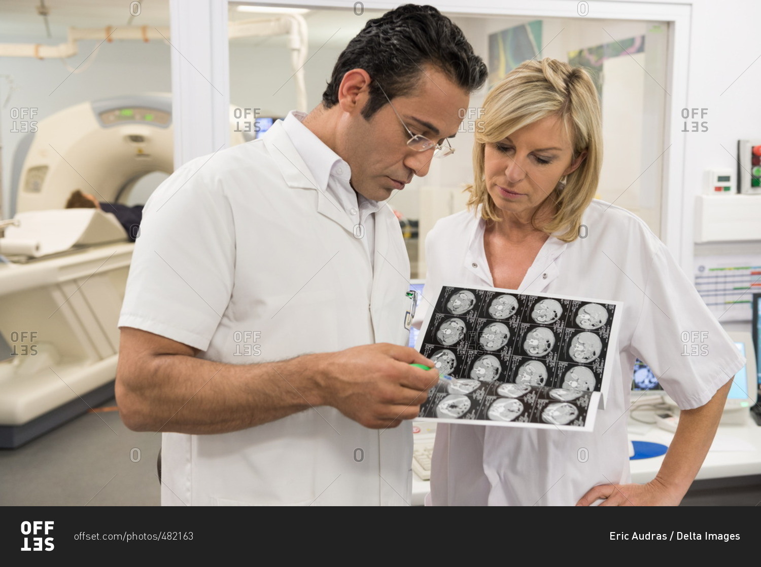 Doctors examining MRI scan report in medical scan room