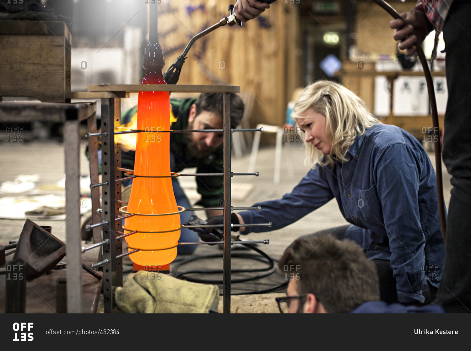 Glass makers shaping hot glass