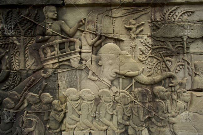 Relief carving with man on elephant at Angkor Thom Temple in Angkor Archaeological Park, Cambodia