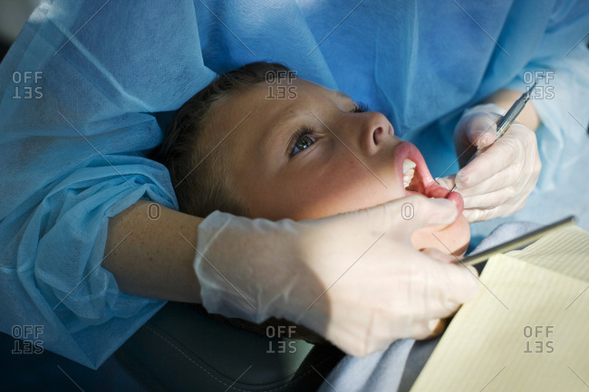 Young boy being examined by a dentist