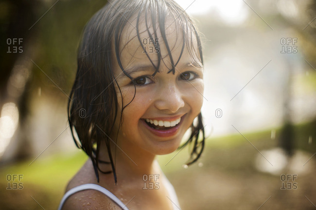 Smiling young girl with wet hair stock photo - OFFSET